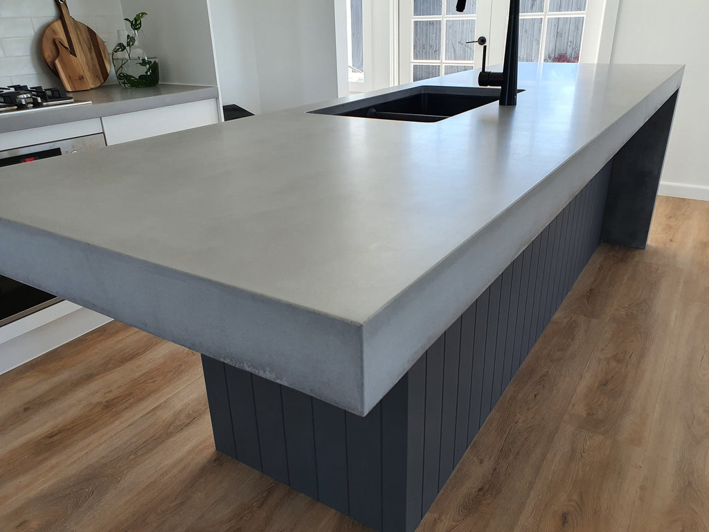 Custom concrete bench top by DLH Designs with cantilevered one and and shadow line waterfall at the other end