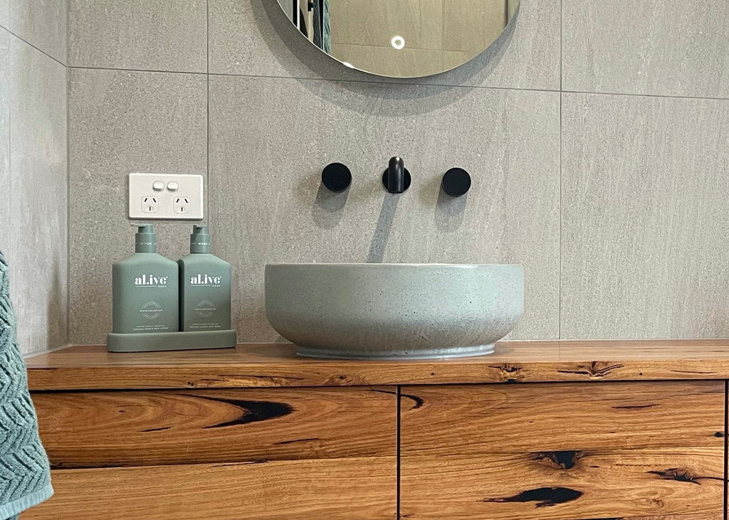 Lauren Round Concrete Basin by DLH Designs in Sage on a timber vanity