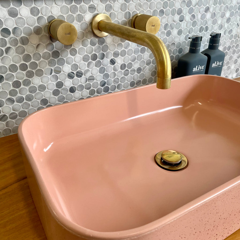 IDK wall mount taps by Par Taps in Brushed Brass with a concrete basin by DLH Designs